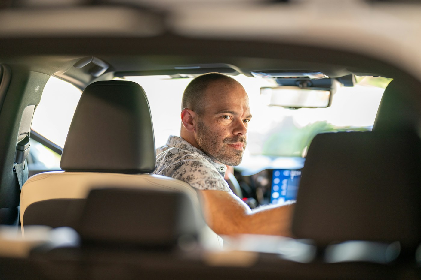 View from the back seat of a car with the driver turning around